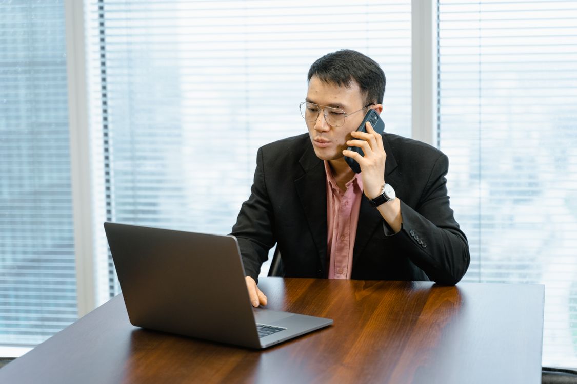 Small business owner missing a call at his desk - how much missed calls cost a small business